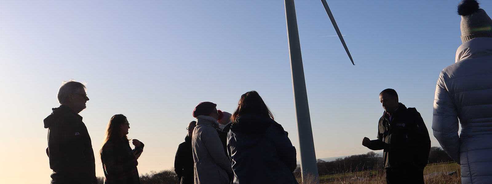鶹Ƶ's wind turbine with people attending a talk on sustainability.